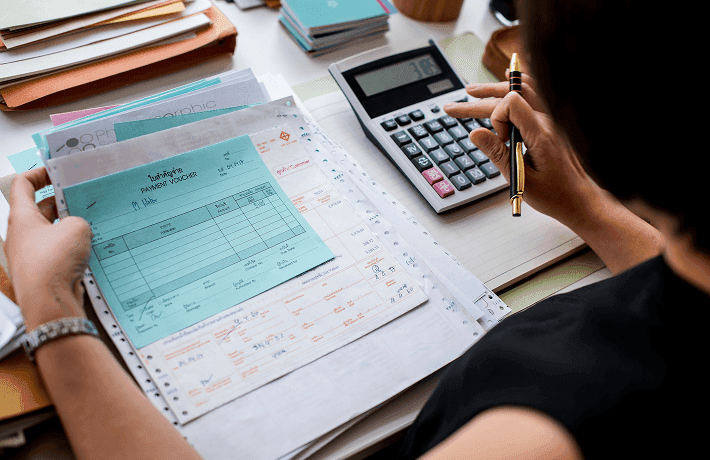 asian-woman-working-through-paperwork.png
